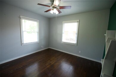 Spare room with wood-type flooring and ceiling fan
