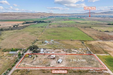 Overview of rural landscape with a mountainous background and property parcel outlined