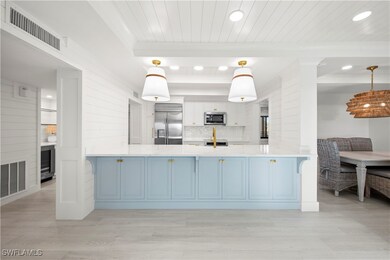 Kitchen with pendant lighting, backsplash, blue ca