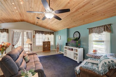 Living room with lofted ceiling, french doors