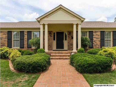 Foyer opens from this great front porch. Foyer offers crystal pendant chandelier, chair rail and wood floors.