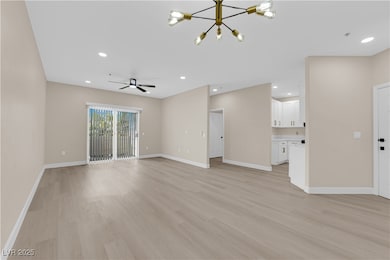 Unfurnished living room with a chandelier, light w