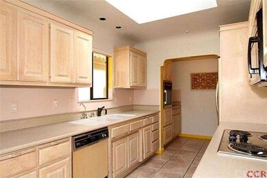 Galley style kitchen with stainless appliances, co