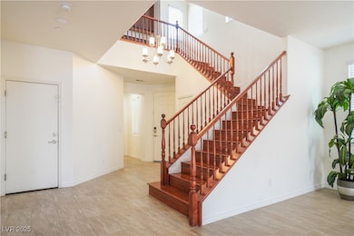 Stairs featuring a notable chandelier, baseboards,