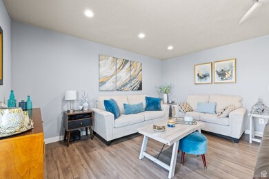 Living room with wood finished floors, recessed lighting, and a textured ceiling