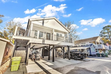 Rear view of house featuring a carport and a balco