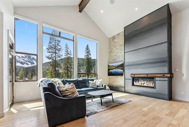 View from kitchen into living room with vaulted ce