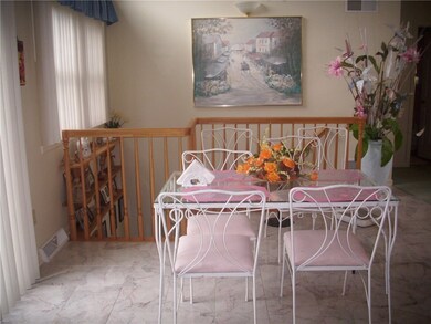 Marble floors accent this diningroom. Sliding door