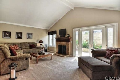 As you enter into the home you are greeted by a spacious Living Room with cathedral ceilings, a gorgeous fireplace and newer French style doors. The home has been newly painted and updated with newer carpet.