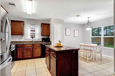 Kitchen features gas range and plenty of cabinet s