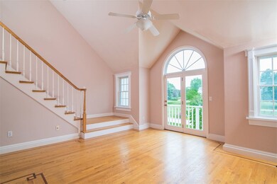 LIVING ROOM WITH DOORS TO DECK OVERLOOKING CENTER