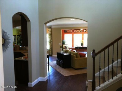 Foyer view kitchen entrance at left arch