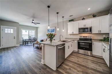 Kitchen featuring stainless steel appliances, a si