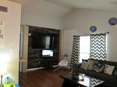 Living area with bar to Kitchen and just off dinin
