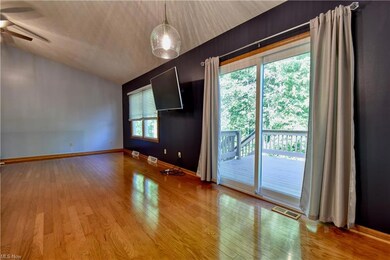Hardwood floored living room with vaulted ceiling