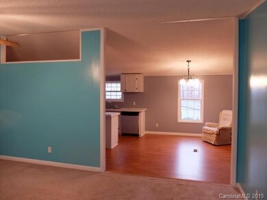 Open floor view from formal living room into forma