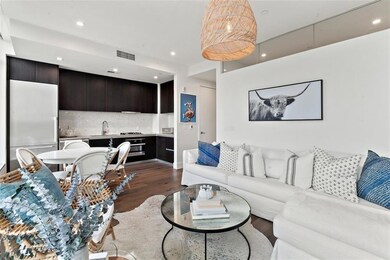 Living area with dark wood-style flooring, visibl
