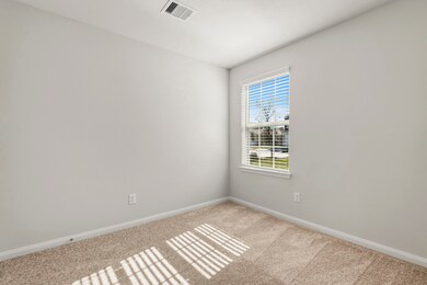 One of the two additional bedrooms in the home.
