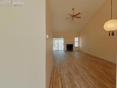 Unfurnished living room with a ceiling fan, high v