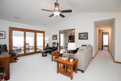 Vaulted great room leads to 3 Seasons Porch throug