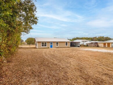 View of front of property with trees lining left s
