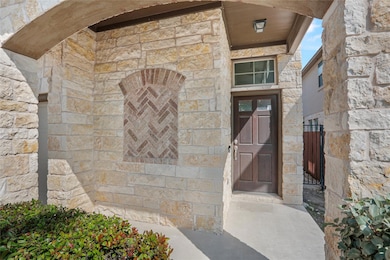 Entrance to property featuring stone siding