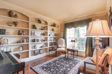 Study features hardwood floors, 2 piece crown molding, built-in shelves, and custom window treatments.