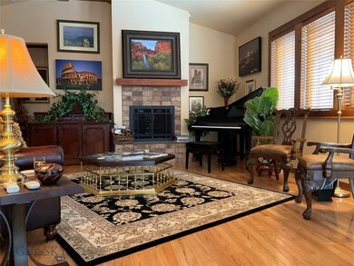 Spacious living room features vaulted ceiling, gas