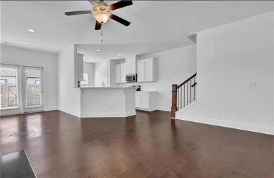 Unfurnished living room featuring dark wood finish