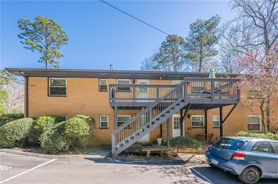 View of property featuring stairway and uncovered 