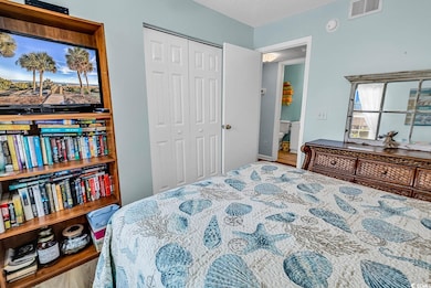 Bedroom featuring visible vents and a closet