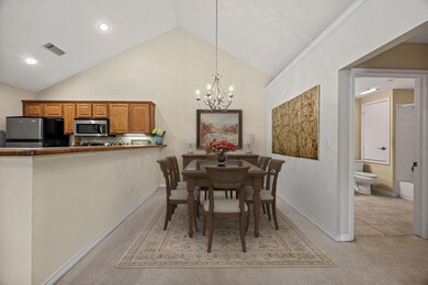 Spacious dining room with vaulted ceiling.