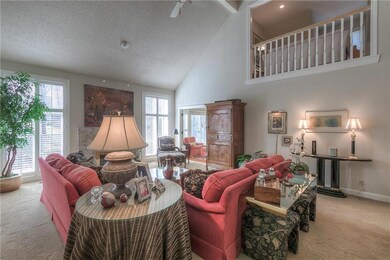 Spacious great room with high vaulted and beamed c