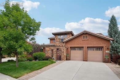 Mediterranean / spanish home with a garage and a f