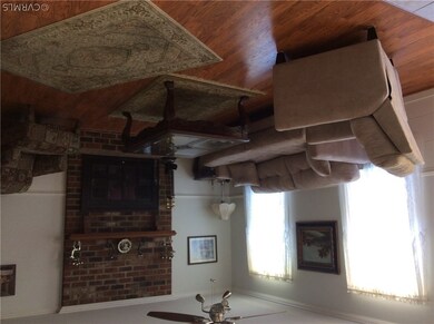 living room - laminate floors, brick FP, ceiling fan, crown molding, chair rail
