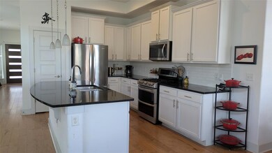 Kitchen featuring stainless steel appliances, bac
