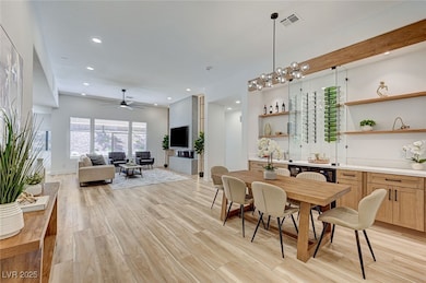 Dining space with recessed lighting, light wood fi