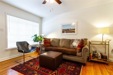Living area featuring ceiling fan, plenty of natu