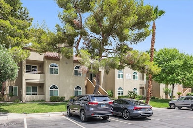 View of building exterior with uncovered parking