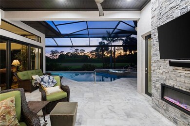 View of pool featuring a patio area, a lanai, and an outdoor living space with a fireplace