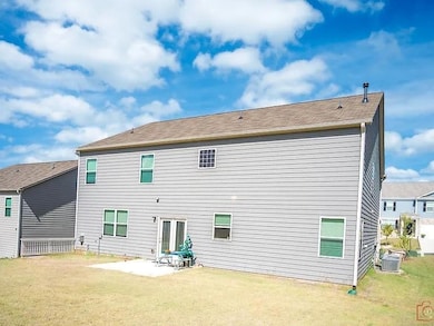 Back of property featuring a yard and a patio area