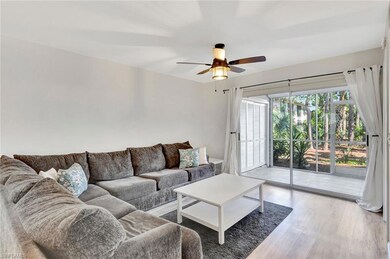 Living room with light wood finished floors and ceiling fan
