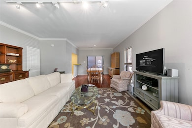 Elegant crown molding adds a touch of sophistication to the open living space.