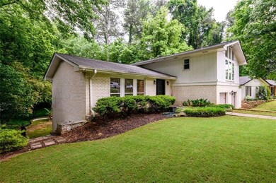 Tri-level home with a garage, brick siding, a fron