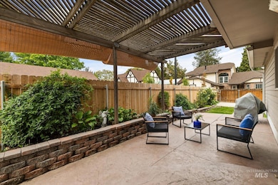 Fenced backyard with a patio, an outdoor living space, and a pergola