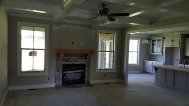 Living room just off of the kitchen - gorgeous coffered ceiling, tons of trim. (not actual home for sale.)
