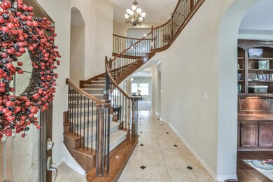 Spactacular Spiral Staircase with elegant Iron Balusters is showcased in the impressive 2 story Foyer