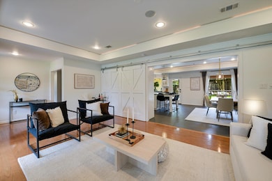 Living area featuring a barn door, wood finished 