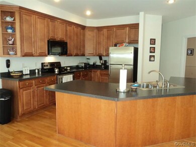 Kitchen with stateless steel appliances and maple 
