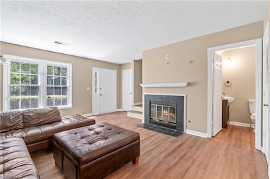 Living room with baseboards, light wood-style floo